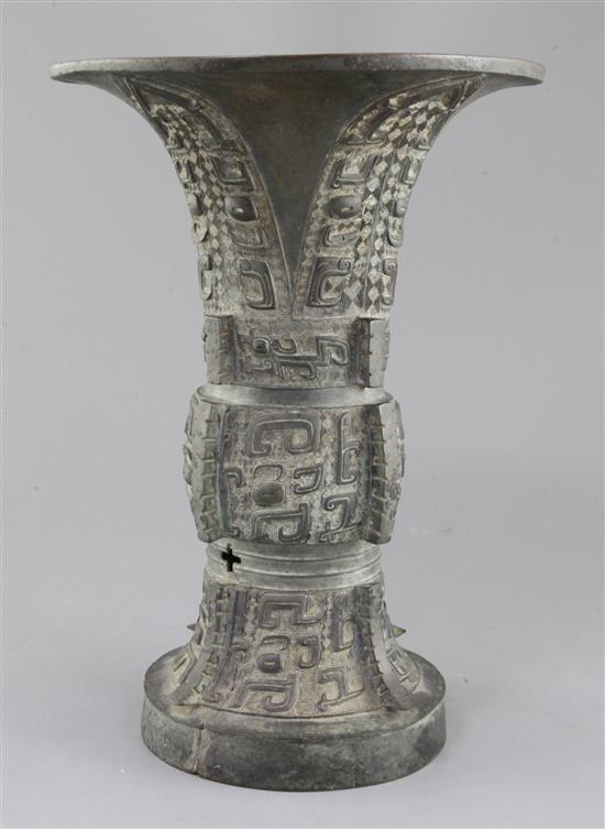 A Chinese archaic bronze ritual wine vessel, Zun, late Shang/early Western Zhou dynasty, 35.5cm high, split to foot